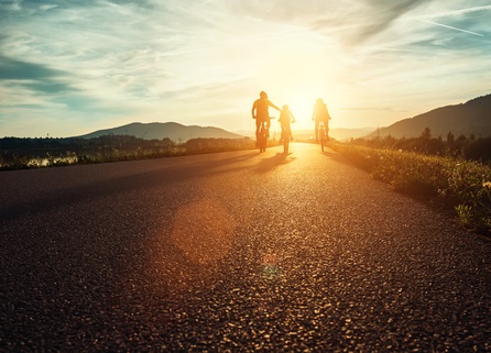 Family Riding Bikes at Sunset