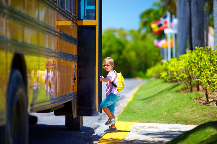 Autistic child getting onto school bus