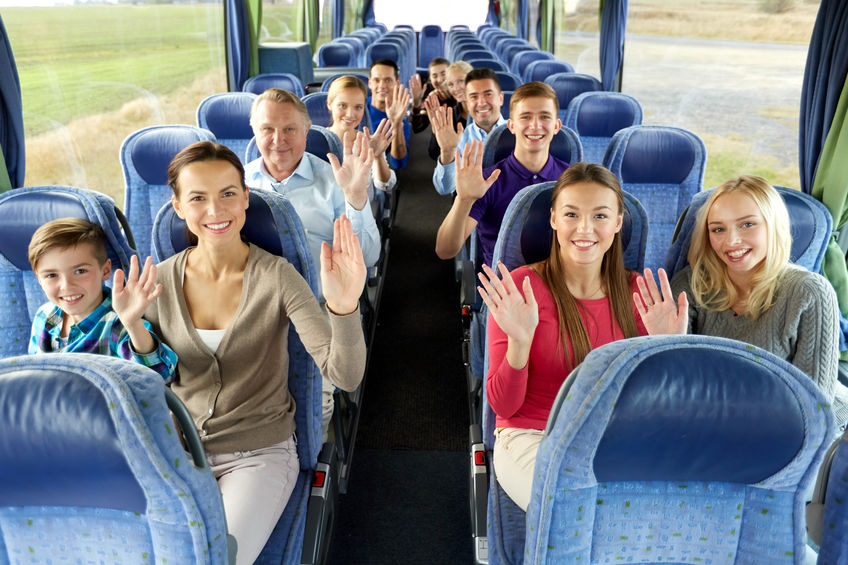 Group of happy church passengers travelling by bus