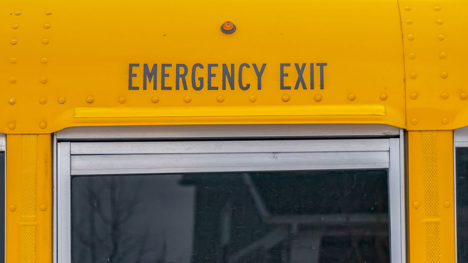 Panorama Exterior of a yellow school bus with a close up view of its glass window