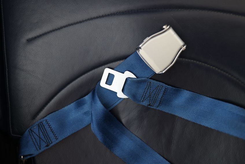 Safety belts lying on passenger seat of school bus