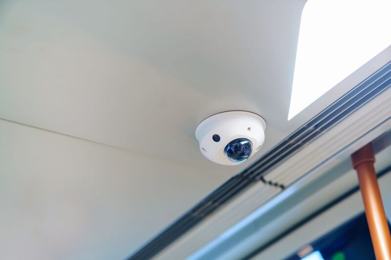 Surveillance camera with microphone on the ceiling in a bus
